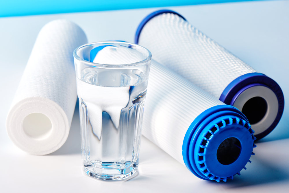 Water,Filters.,Carbon,Cartridges,And,A,Glass,On,A,White